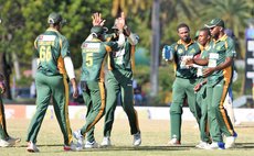 Alick Athanaze is congratulated by teammates after taking his first wicket