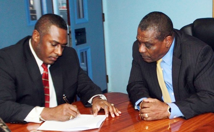 BELLO's Managing Director Michael Fagan and AID Bank's Manager Julius Corbet sign agreement