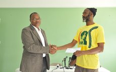 ECCO chairman Marie hands cheque to Aaron James