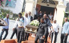Relatives and friends carry the coffin of Alec Gage to his final resting place