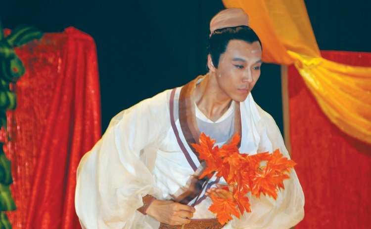 An actor from the Chinese group performs at the Arawak House of Culture