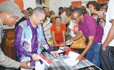 Dr. Irving Andre signs book at the book launch
