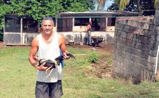 Andrew Green holds one of his chickens