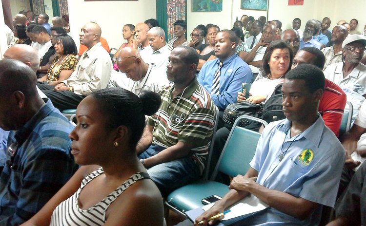 Persons listen to speakers at discussion on good governance