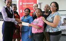 Khahill and parents Karleen and Anthony Richards recieve cheque from Scotia Bank staff