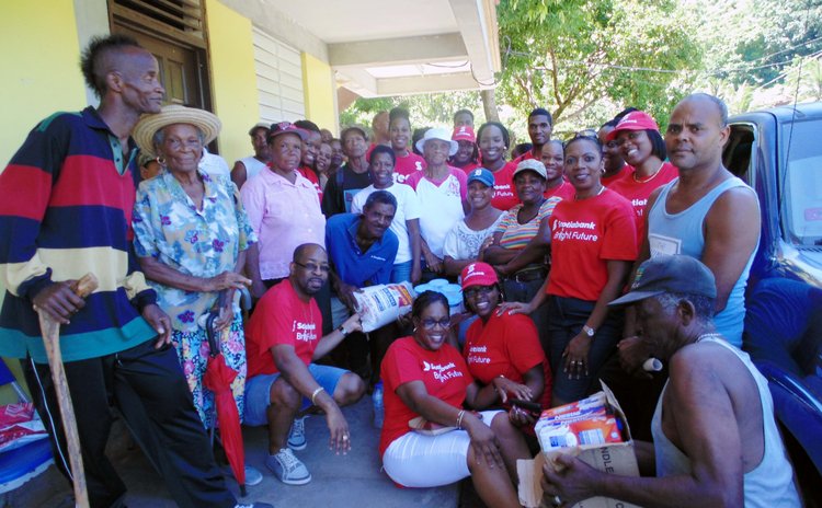Staff of Scotiabank pose with persons who recieved donations