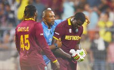 Gayle and  coach Simmons congratulate Braithwaite at the end of the World T20 Finals