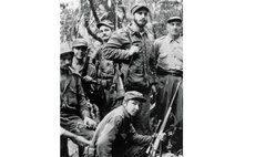 Unlocated image taken in 1958 shows Fidel Castro (2nd R), Raul Castro (Down) and Ernesto Guevara (2nd L) posing with arms. 