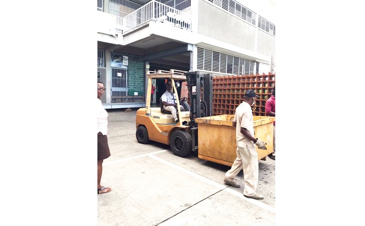 Charles drives forklift at business compound