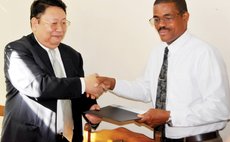Chinese Ambasador Jiangning ,right exchange agreement with Education Minister Petter St .Jean