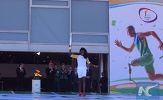 Brazilian volleyball player and the first torchbearer in Brazil, Fabiana Claudino, leaves the Planalto Palace with the Olympic torch, in Brasilia, Brazil on May 3, 2016. (Xinhua/Rahel Patrasso)