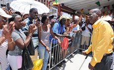 Dr Sam Christian  greets well-wishers at the ferry terminal in Roseau
