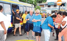 Before COVID-19:Tourists leaving a bus on the Roseau Bayfront after a tour
