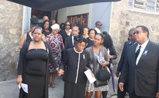 Bynoe's mom (second from left) and daughter, front left, at funeral service; brother, extreme right front