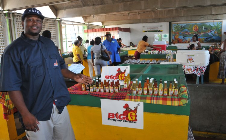Big G displays pepper sauce at an expo at the Roseau Market