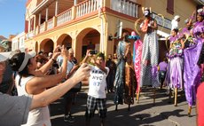 Tourists take photos of Bwa Bwa on the parade