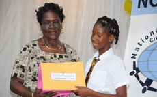 Marie Wilkins Scholarship delivered by Mary Wilkins to Zaria Kiarra Kelis Bowers of Pointe Michel