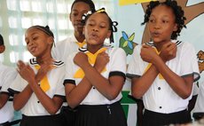 Students at the Roseau Primary School  sing at a function