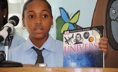  A student diaplays a book she has been reading 