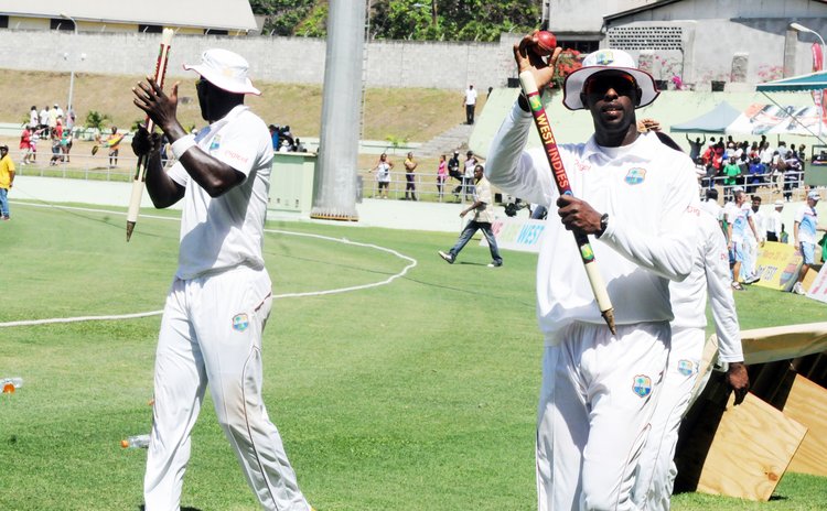 Shane Shillingford, right, wave to fans after a West Indies win at the Windsor Park