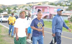 Linton, front, and afew supporters walks for Layou