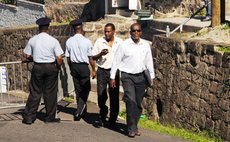 Linton, front right, and Dr Fontaine cross police barricades on their way to the Electoral Office