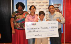 Courts top reader, centre, shows his prize