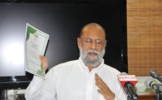 Ray Harris holds up committe report on changes to the Sexual Offences Act
