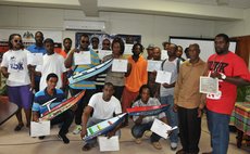 Graduates of the NEP course pose with certificates and models