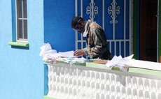 Police Officer search through damaged court documents after Hurricane Maria