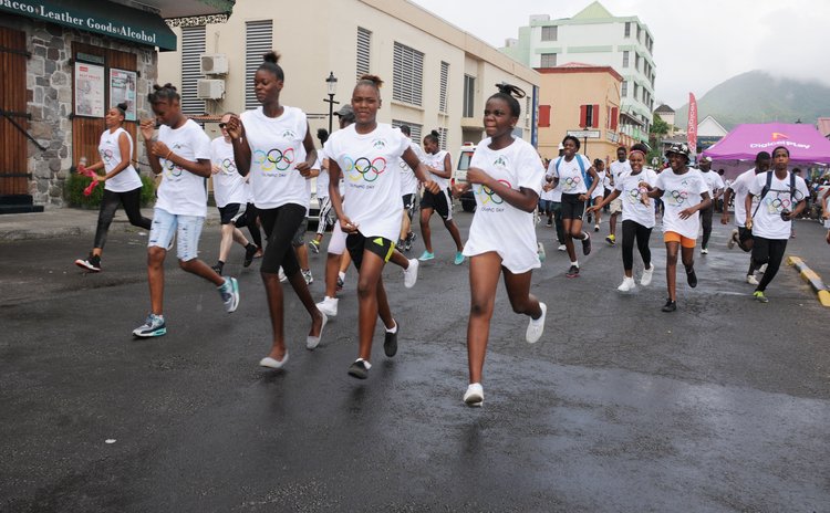 Runners participate in Olympic Day Run on Saturday 18 June on the Roseau Bay Front
