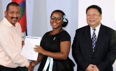 Left to right: Dr Casius Darroux, scholarship receipient and Chinese Ambassador Li Jiangning