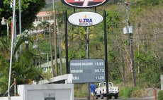 Petrol prices on display outside gas station at Canefield