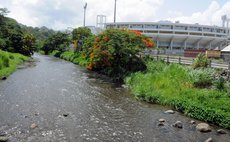 On the bank of the Roseau River near the Windsor Park Stadium