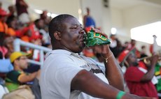 Man blows "Dominican" conch shell at the Windsor Park yesterday