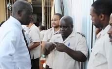 Dr Sam Christian, left, speaks to Roseau Post Office workers this morning at the strike