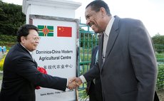 President Savarin (right) and Chinese Ambassador Li Jiangning shake hands after cutting ribbon to officially open the Dominica-China Modern Agricultural Centre at One Mile Portsmouth