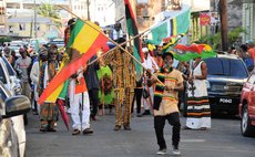 Man waves flag at African Liberation Day parade 2018
