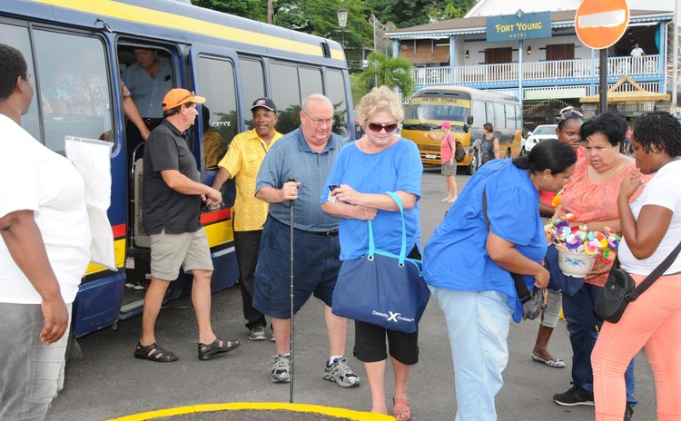 Cruise passengers leave bus after a land tour in Dominica today