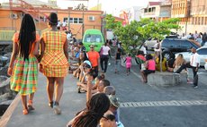 People wait for friends and relatives arriving for the WCMF at the Roseau Ferry Terminal this evening