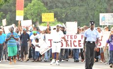 Police escort marchers near Goodwill bridge