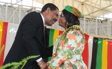President Charles Savarin kisses Dr. Etienne after she receives the Dominica Award of Honour