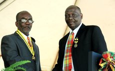 Bishop Bill Daniel,right, received award from President Eliud Williams in 2012