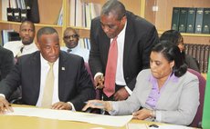 AIDB chairman Martin Charles, left, AIDB Manager Corbette and Finacial Secretary Rosmond Edwards at the signing ceremony