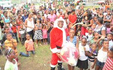 Robert Tonge in Santa custume and children at Christmas function