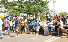 Villages relax on debris used to block roads
