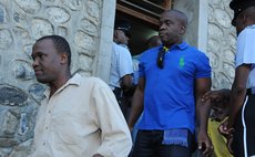 Lennox Linton, back, and Dr. Thompson Fontaine leave the court after the case at the St Joseph Magistrate's Court on Tuesday 8th December 2015