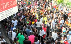 J'ouvert crowd near the Sun's office on Independence street