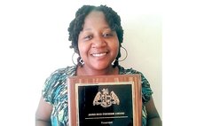 Dawn Francis shows off her award