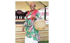 In national dress, Delia Cuffy Weekes